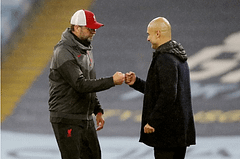 Manchester City manager Pep Guardiola and Liverpool manager Jurgen Klopp bump fists after the match at the Etihad Stadium in Manchester on November 8, 2020