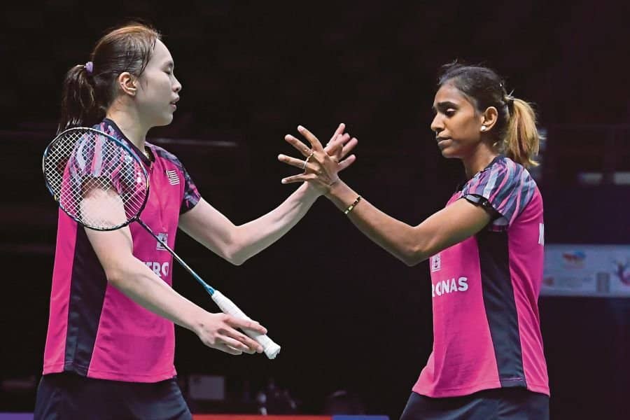 Pearly Tan (left) and M. Thinaah celebrate after beating Thailand’s Jongkolphan Kititharakul and Rawinda Prajongjai in their Uber Cup match on Monday.